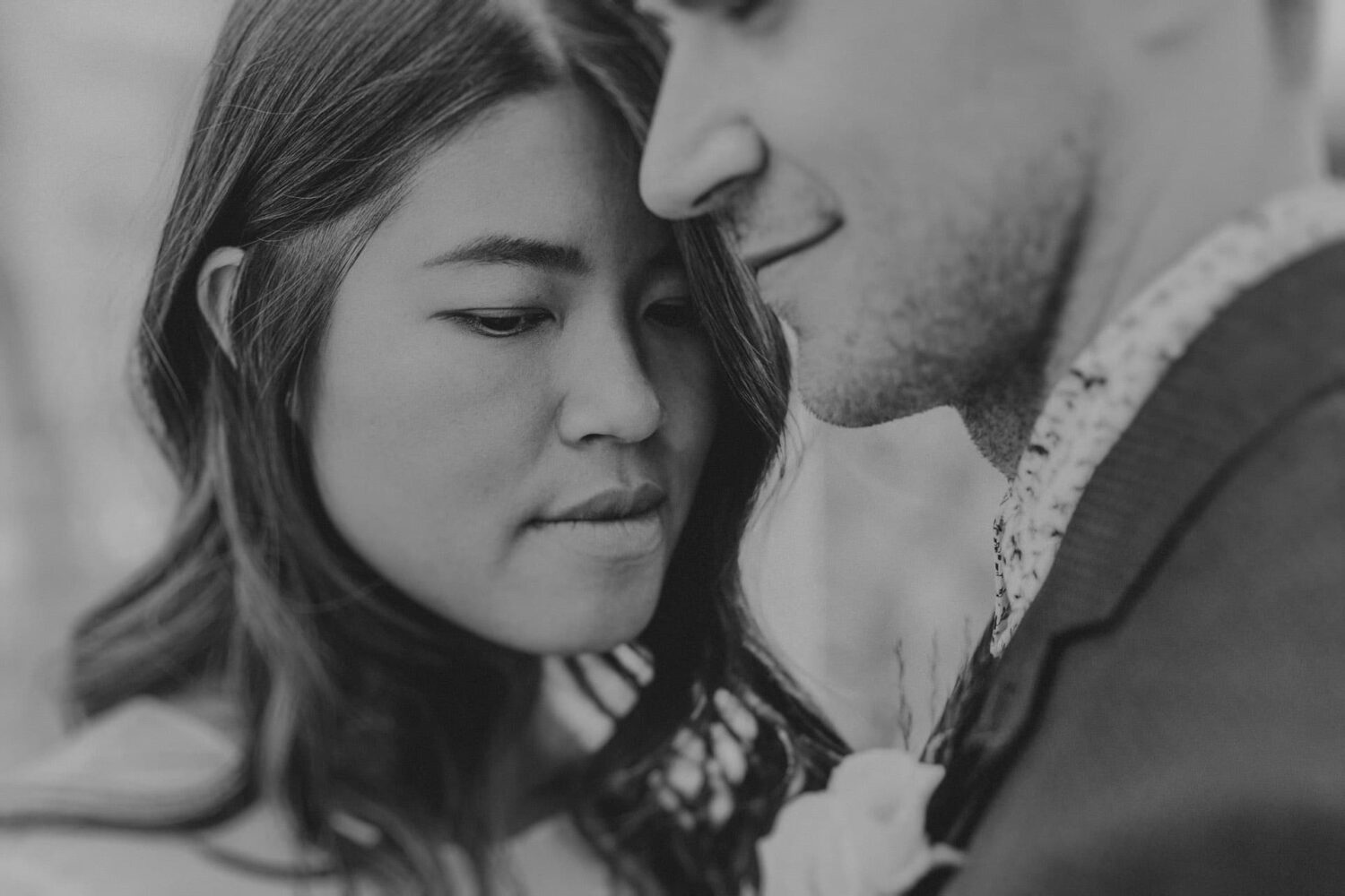 Intimate close up black and white photo of a bride and groom
