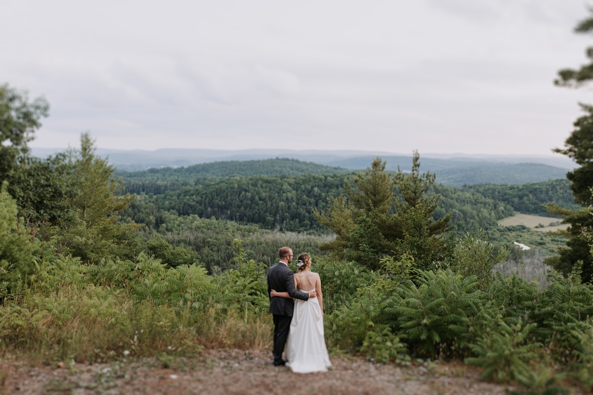 A couple standing cliff side at Le Belvedere on their wedding day