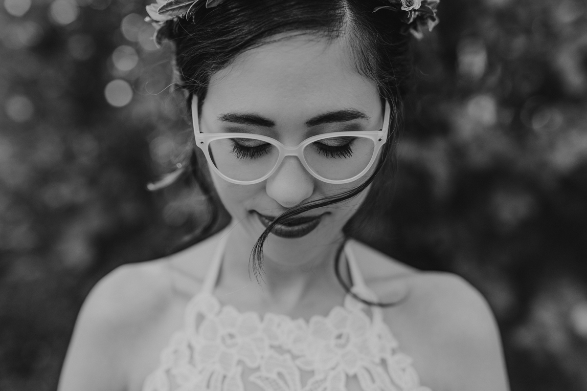 Black and white portrait of a bride wearing glasses