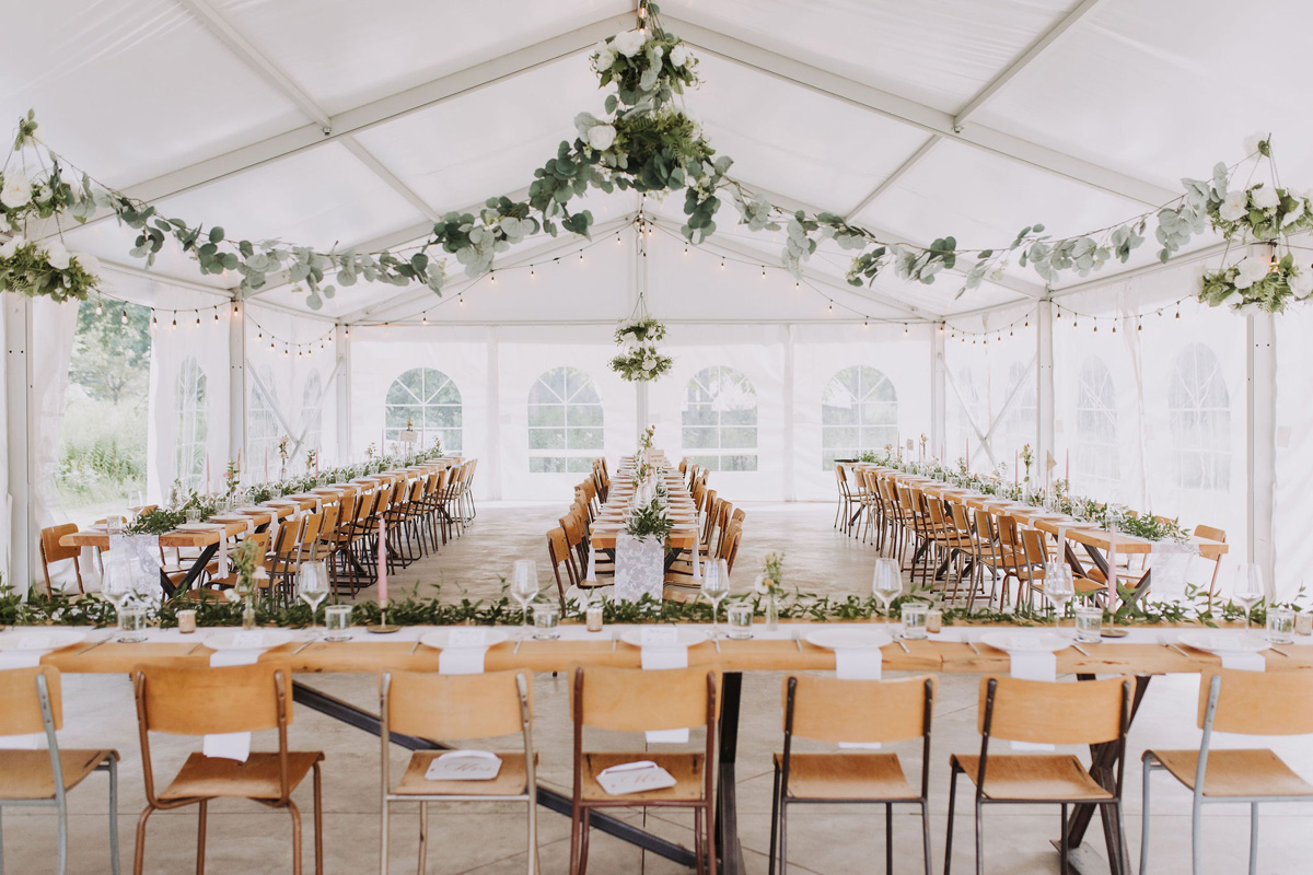 Tent with harvest tables at PEC wedding venue 100 Acre Wood