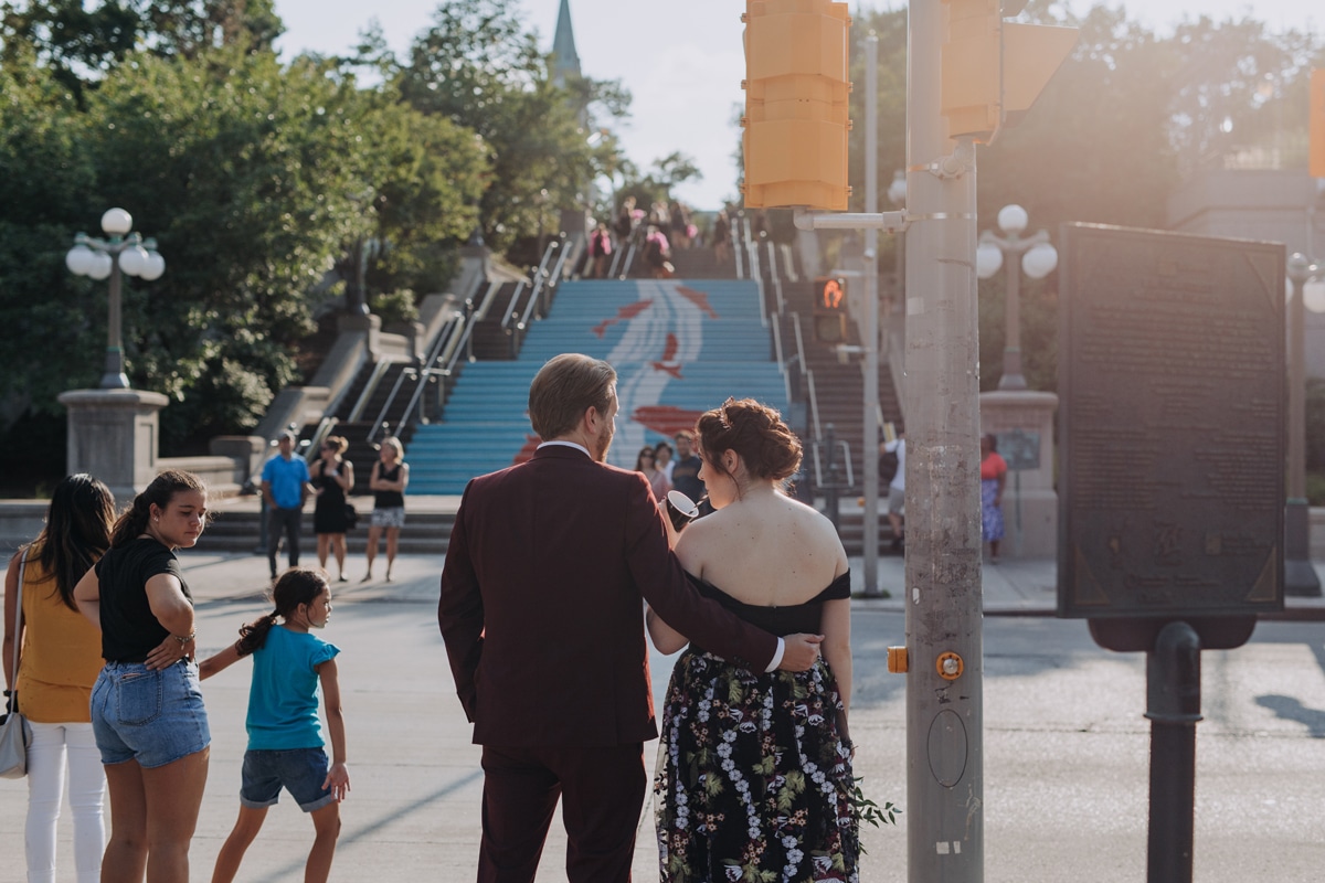 Couple waiting to cross the street on their wedding day in the byward market